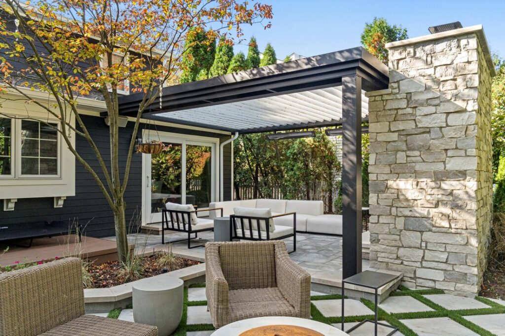 outdoor pergola with seating by seasonal landscape solutions